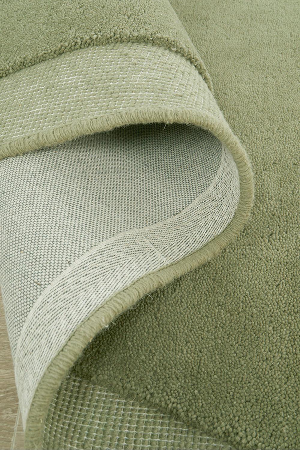 Cloe Moss Rug featuring solid textured pile in moss green with olive accents on cream backing, hand-tufted wool