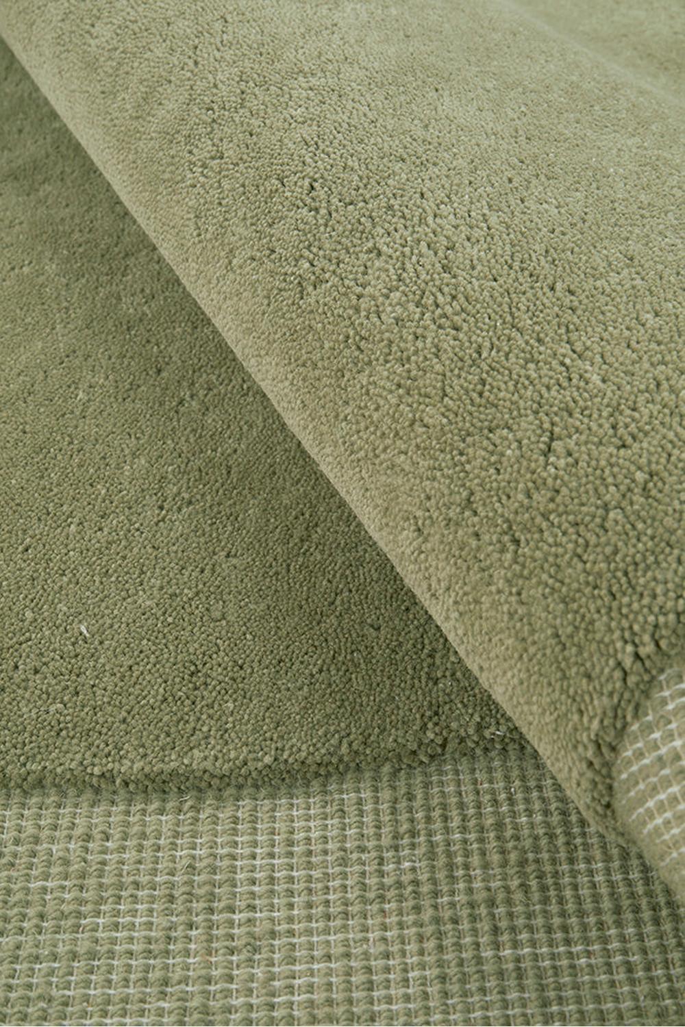 Cleo Moss Rug featuring soft solid shaggy pattern in moss green, sage green on beige woven background, hand-tufted wool