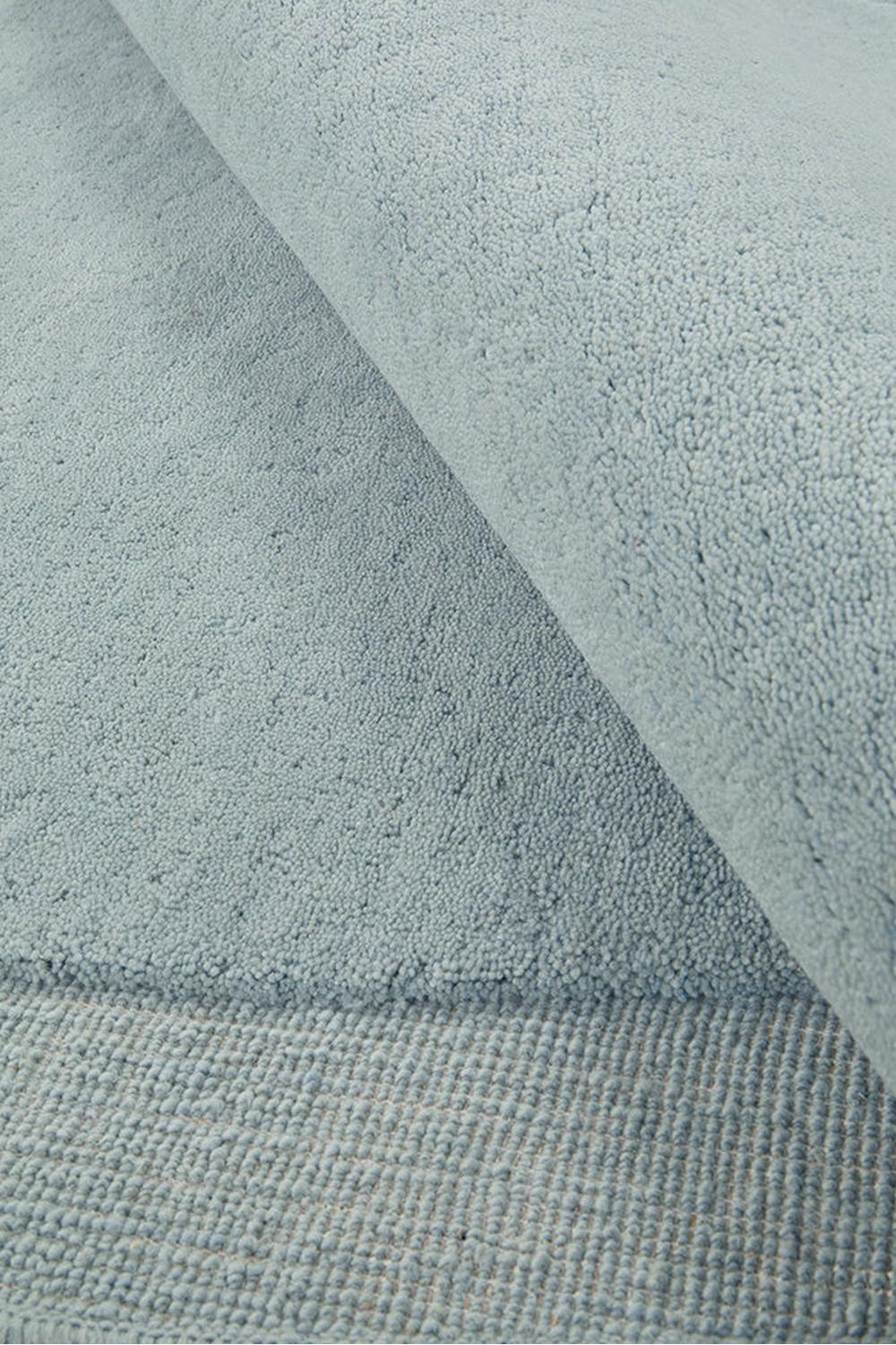 Cleo Sky Rug featuring soft textured abstract wave in sky blue, pale blue and grey-blue on light blue, hand-tufted wool