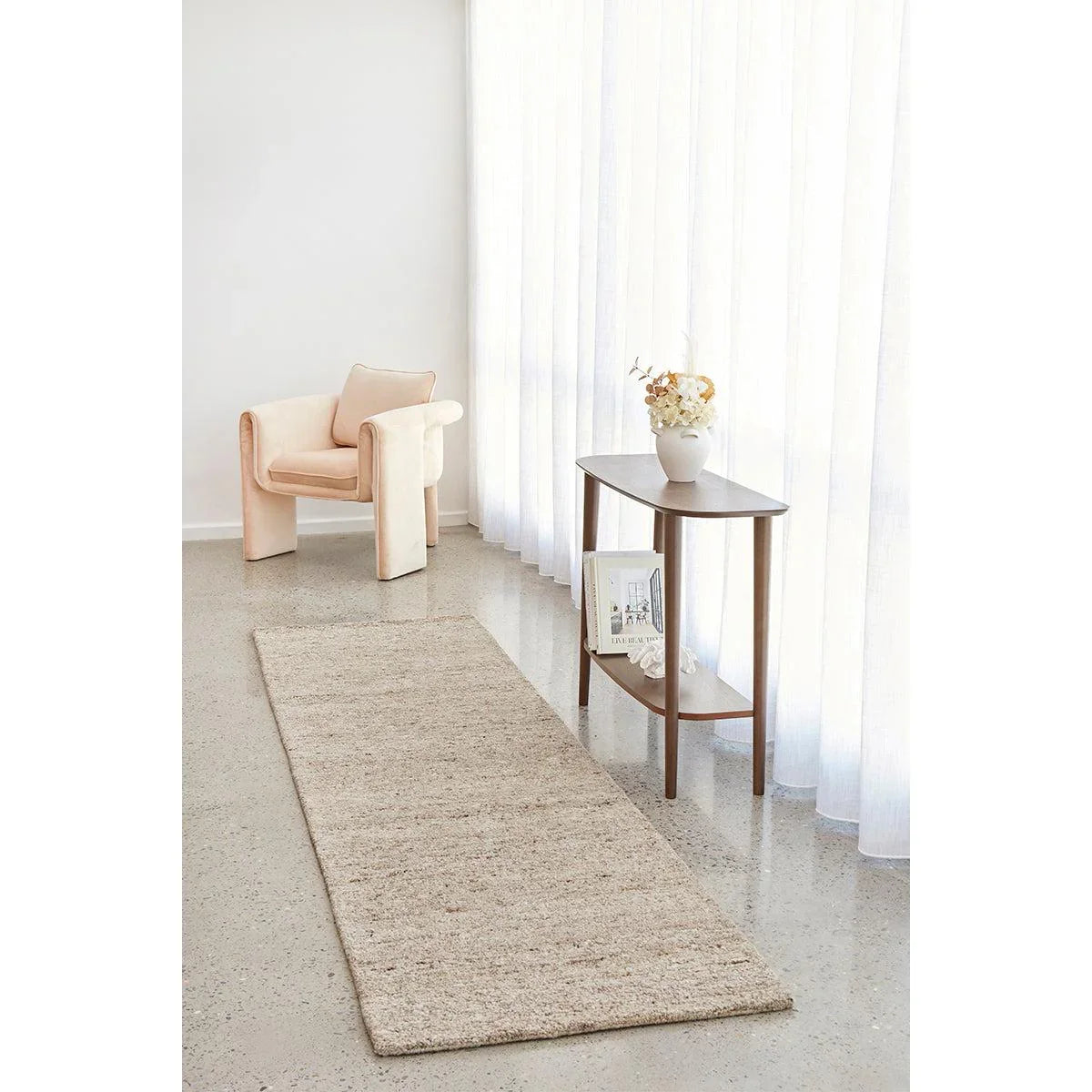 Conscious Loom Embrace Beige Rug featuring textured weave in beige, cream and taupe on pale grey floor, hand-loomed wool