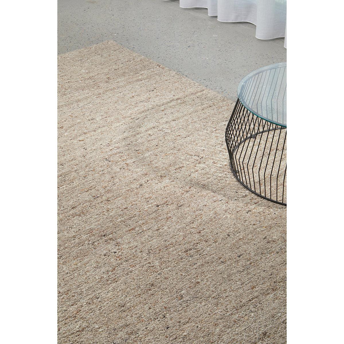 Conscious Loom Embrace Beige Rug featuring textured shag in beige, cream and taupe on light grey floor, hand-tufted wool
