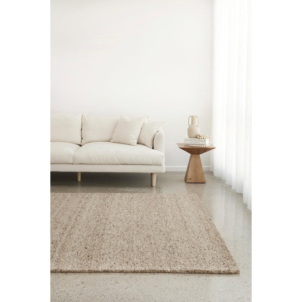 Conscious Loom Embrace Beige Rug featuring textured weave in beige, cream, taupe on light beige floor, hand-woven wool