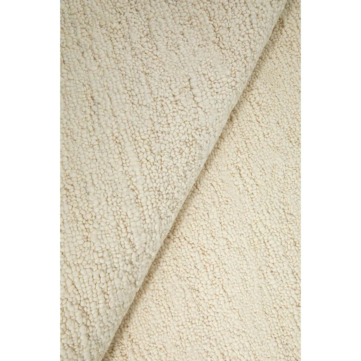 Conscious Loom Embrace Cream Rug featuring textured boucle in cream and ivory on white background, hand-tufted wool