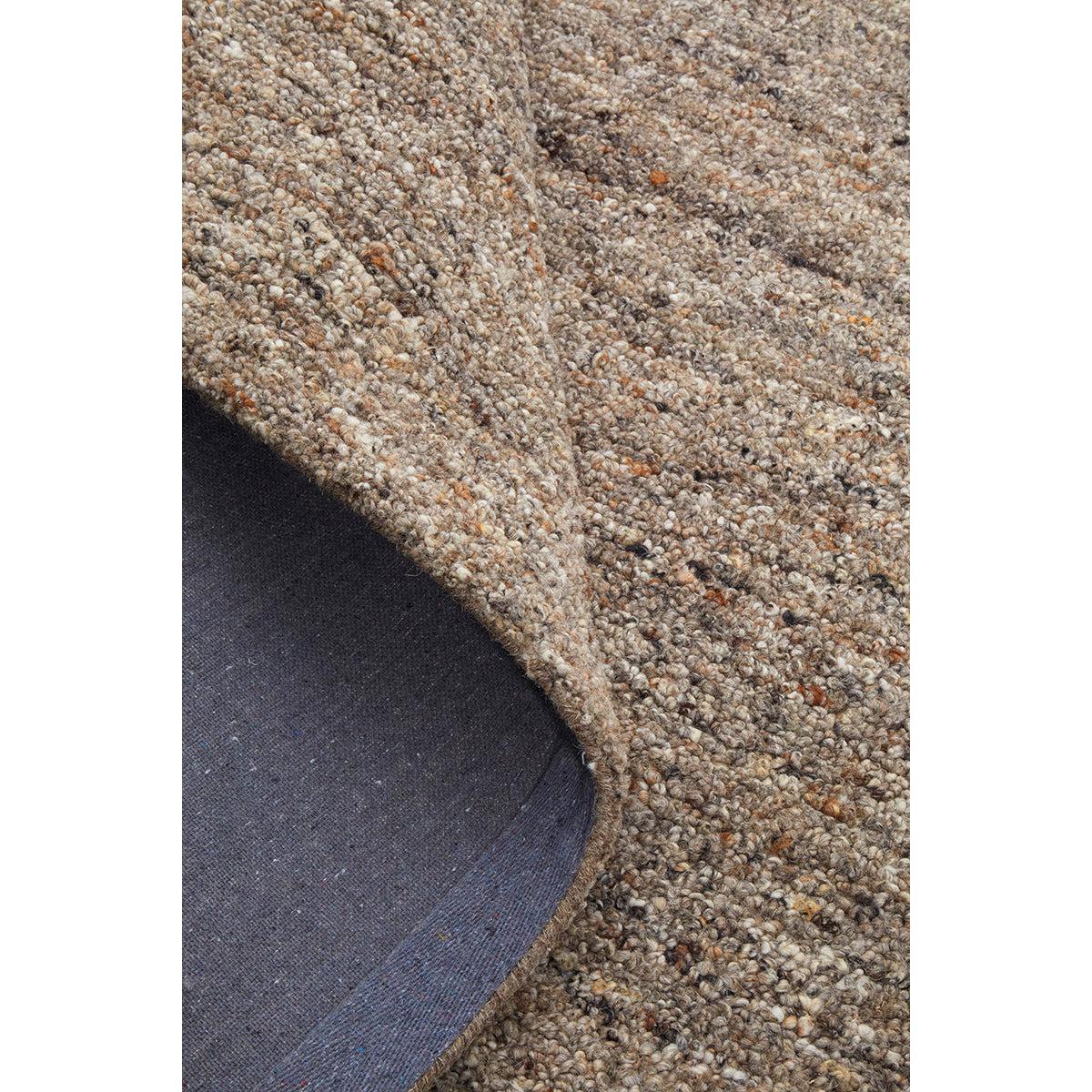 Conscious Loom Embrace Stone Rug featuring textured mottled pattern in beige, taupe and grey on charcoal loom-woven wool
