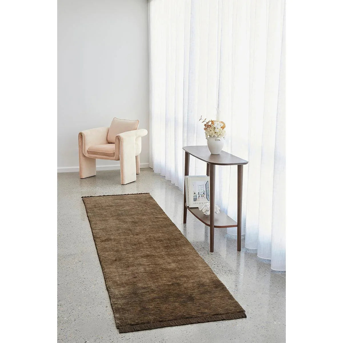 Conscious Loom Kinship Bear Brown Runner Rug with solid texture in dark chocolate brown on grey floor, power-loomed wool