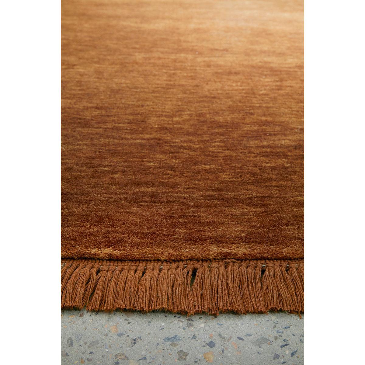 Conscious Loom Kinship Caramel Runner Rug featuring solid texture in caramel, copper-brown on grey floor, tufted wool