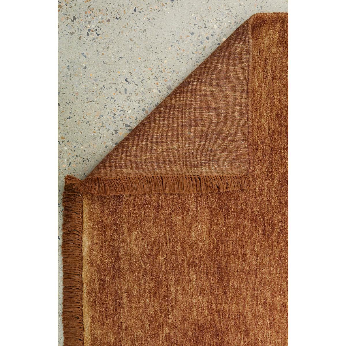 Conscious Loom Kinship Caramel Runner Rug featuring textured solid in caramel, rust on grey terrazzo, hand-loomed wool