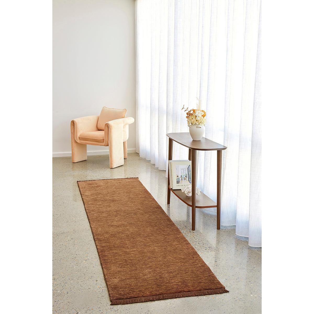 Conscious Loom Kinship Caramel Runner Rug featuring solid texture in caramel brown on pale cream floor, hand-woven wool