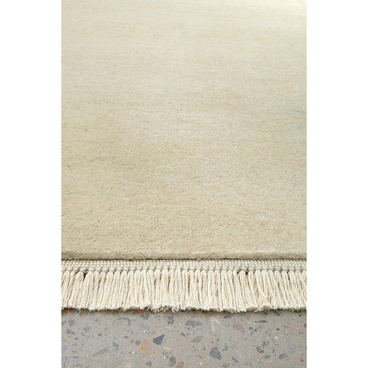 Conscious Loom Kinship Cream Runner Rug featuring solid cream, ivory and beige on light grey floor, hand-tufted wool