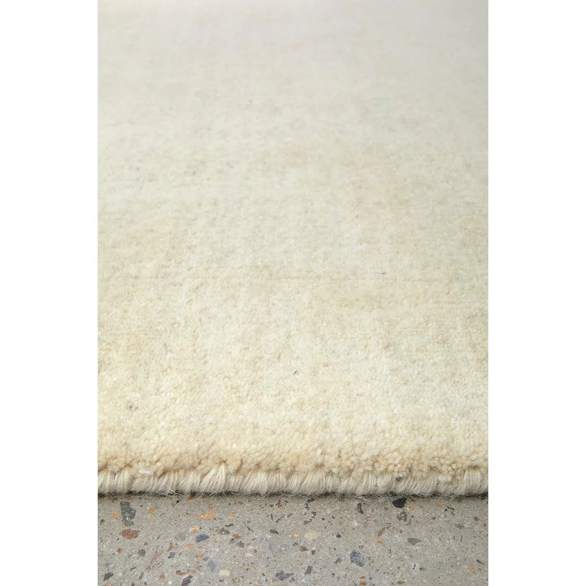 Conscious Loom Kinship Cream Rug featuring solid shag in cream and ivory on cream background, hand-tufted wool