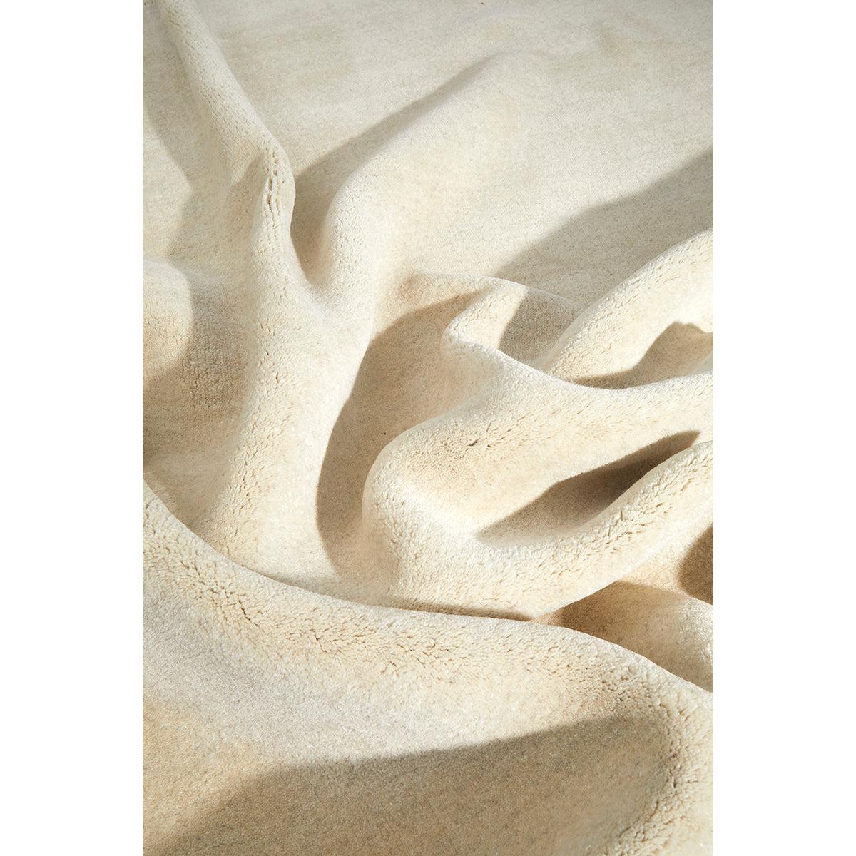 Conscious Loom Kinship Cream Rug featuring solid textured pattern in cream, ivory and beige on white background, woven wool