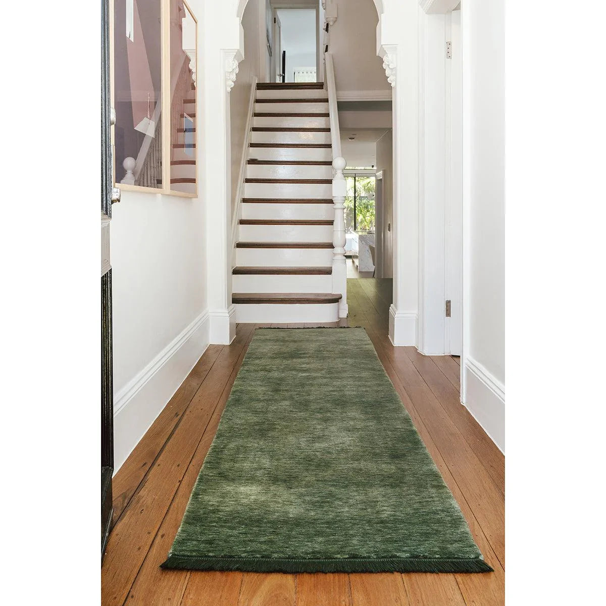 Conscious Loom Kinship Forest Green Runner Rug featuring textured pattern in forest green on honey-brown floor, handwoven wool