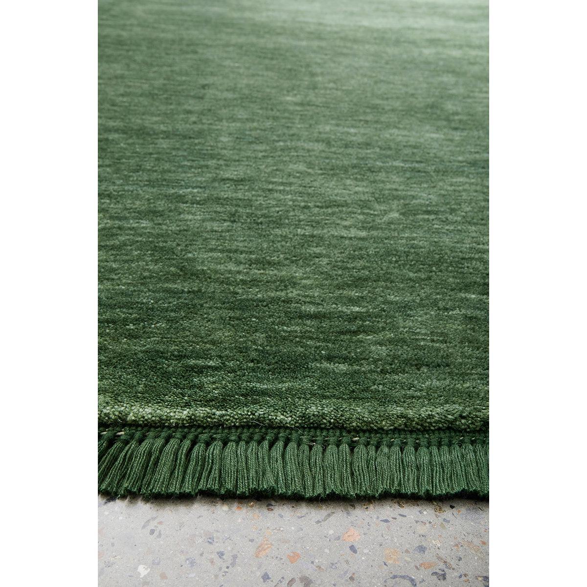 Conscious Loom Kinship Forest Green Runner Rug featuring textured forest green on light grey background, handloomed wool