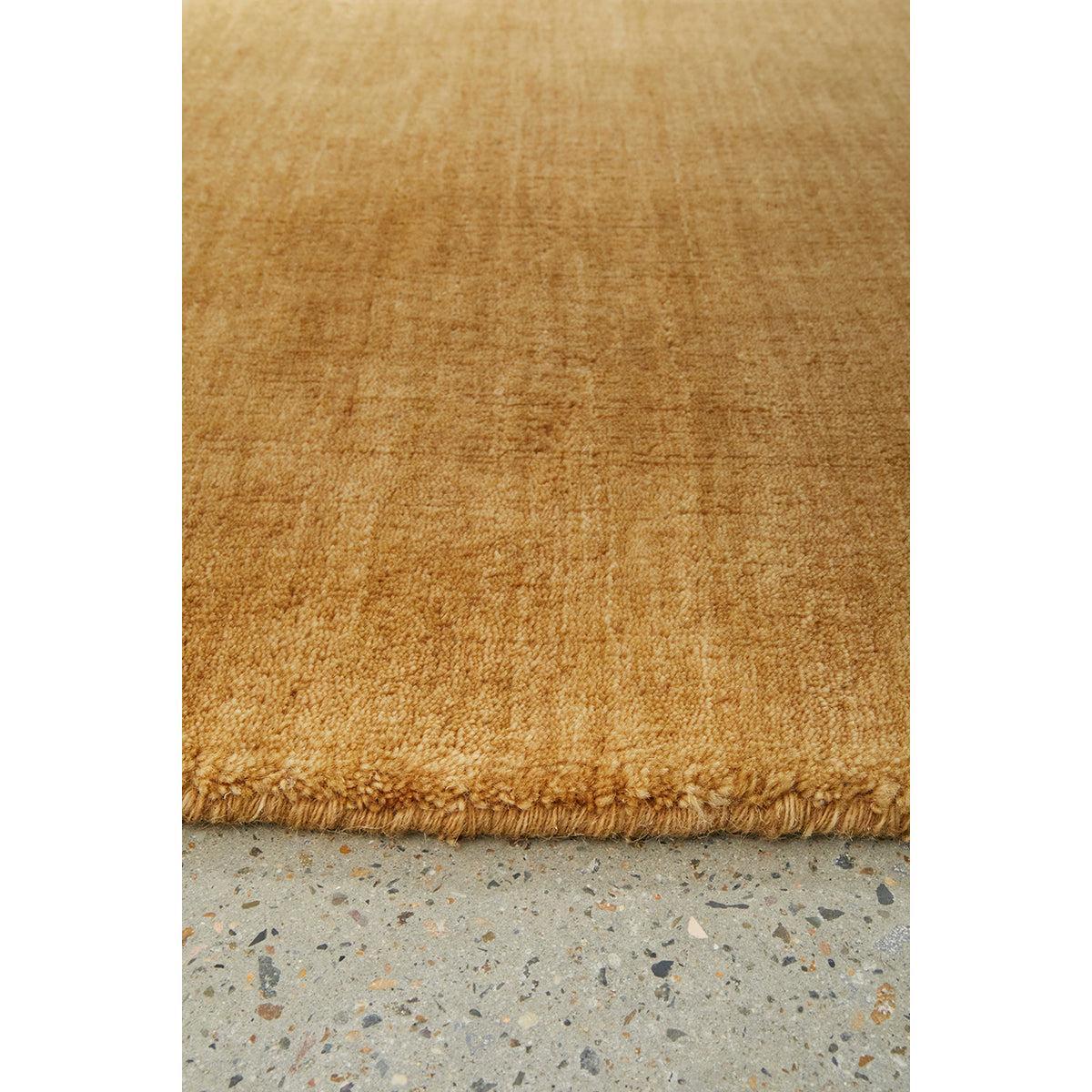 Conscious Loom Kinship Honey Runner Rug featuring honey and amber tones on light grey background, hand-loomed wool
