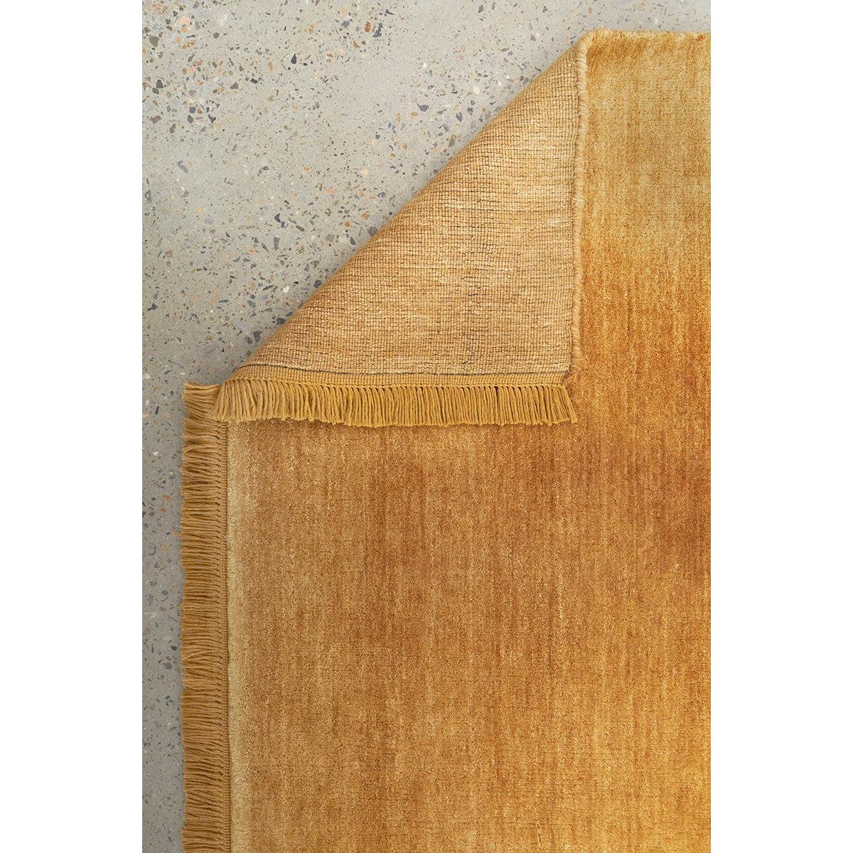 Conscious Loom Kinship Honey Runner Rug featuring textured honey-gold pile in amber and ochre on grey, hand-tufted wool