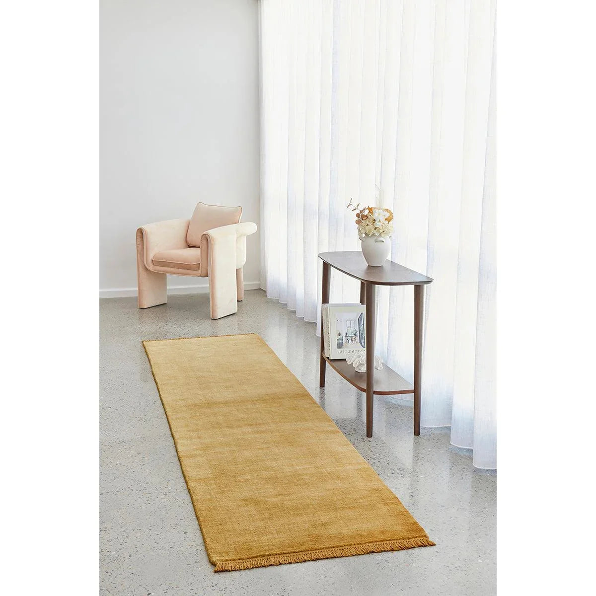 Conscious Loom Kinship Honey Rug featuring solid minimalist design in honey, ochre, cream on grey floor, handwoven wool