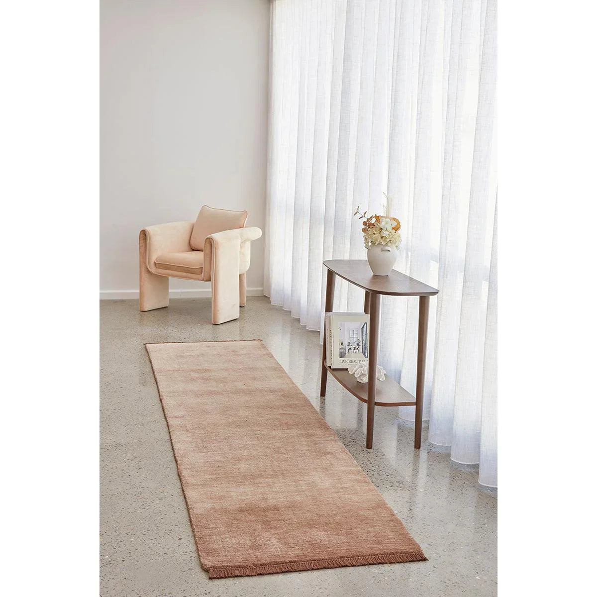 Conscious Loom Kinship Mocha Mousse Rug featuring pattern in blush pink, rose, mocha on grey floor, hand-tufted wool