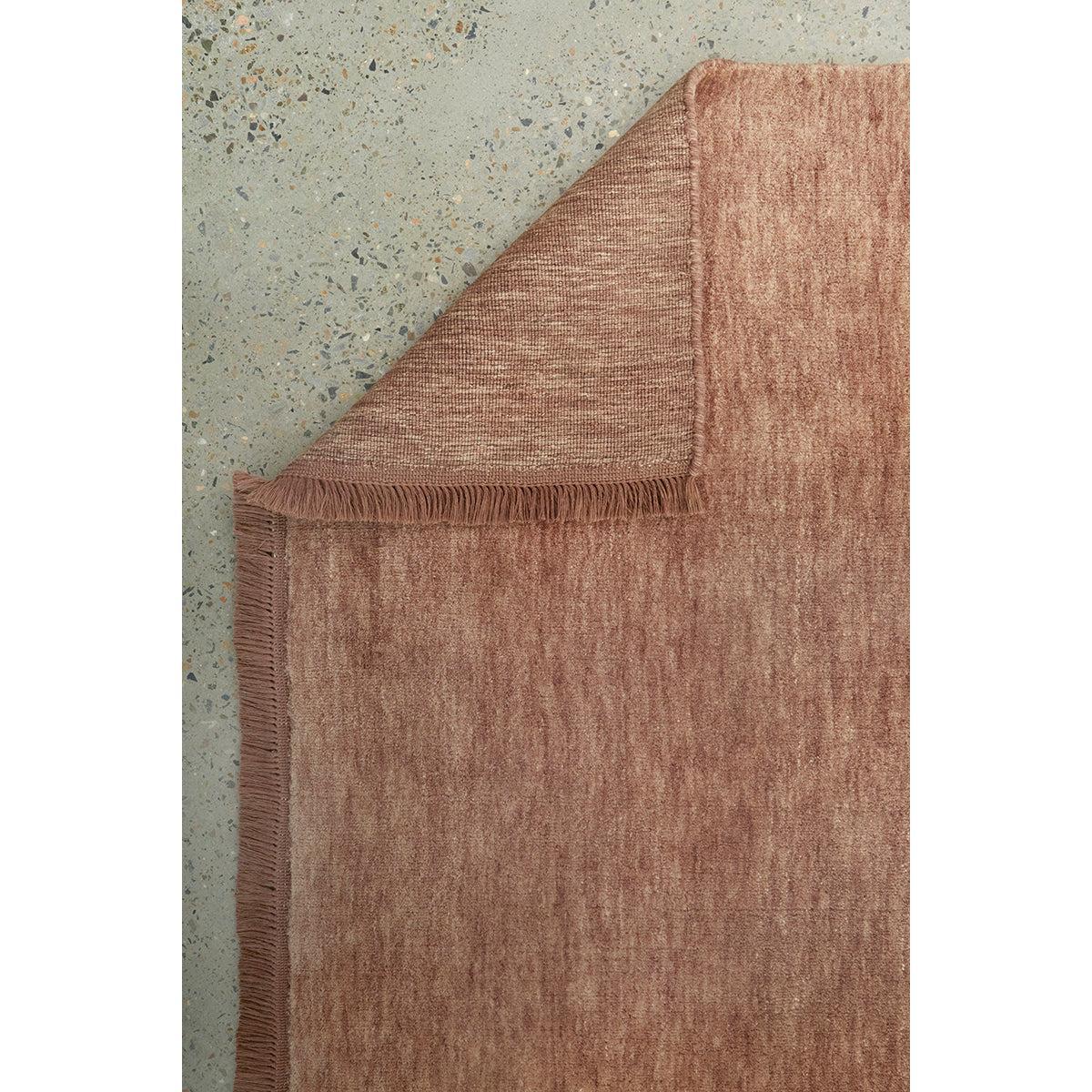 Conscious Loom Kinship Mocha Mousse Rug featuring textured dusty rose on light grey terrazzo floor, hand-knotted wool