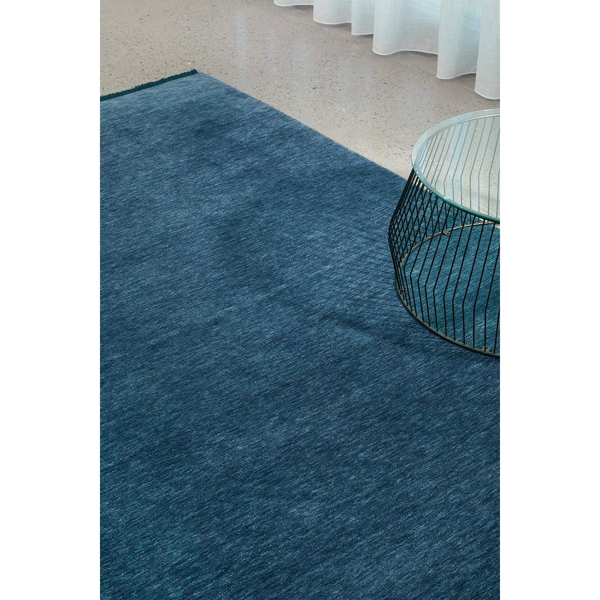 Conscious Loom Kinship Navy Rug featuring textured solid pattern in navy blue on beige background, hand-loomed wool