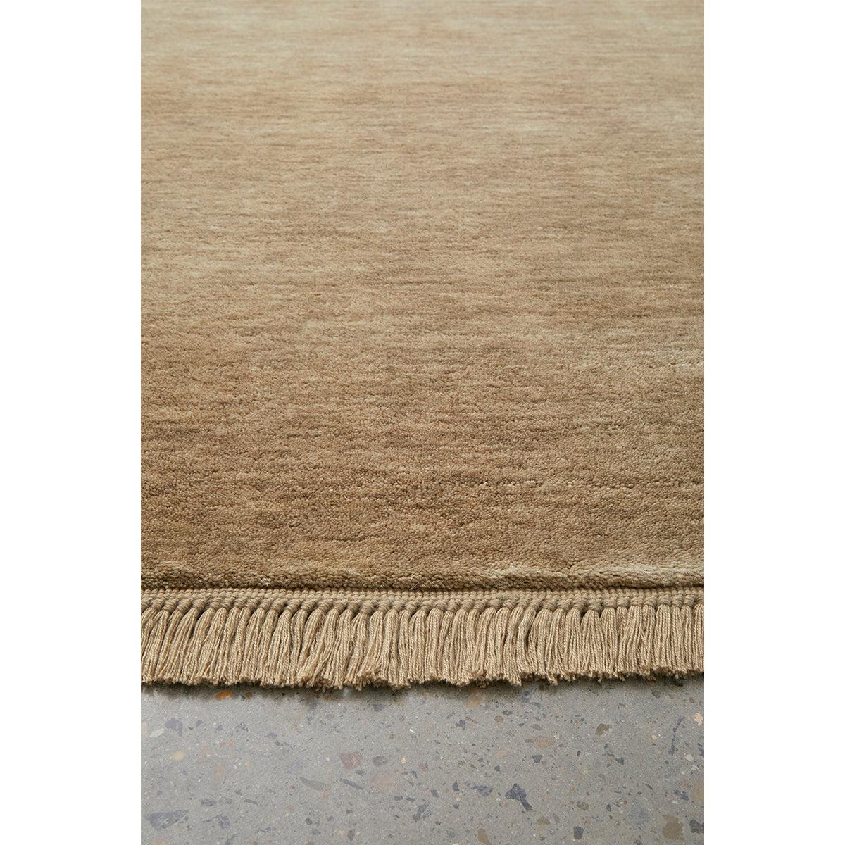 Conscious Loom Kinship Oyster Rug featuring solid plain-weave in oyster, beige and taupe on grey terrazzo handwoven wool