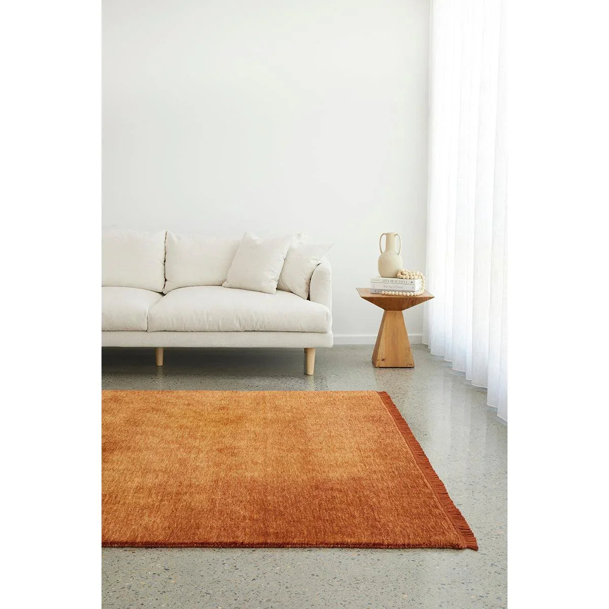 Conscious Loom Kinship Paprika Rug featuring solid-color paprika orange on white ground, cream details, hand-loomed wool