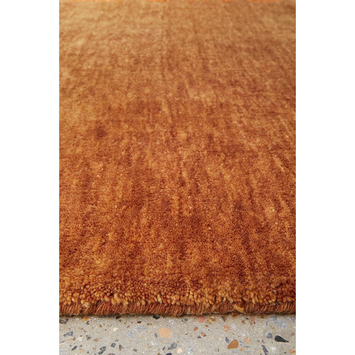Conscious Loom Kinship Paprika Rug featuring solid shag in paprika orange and copper on light grey, hand-tufted wool