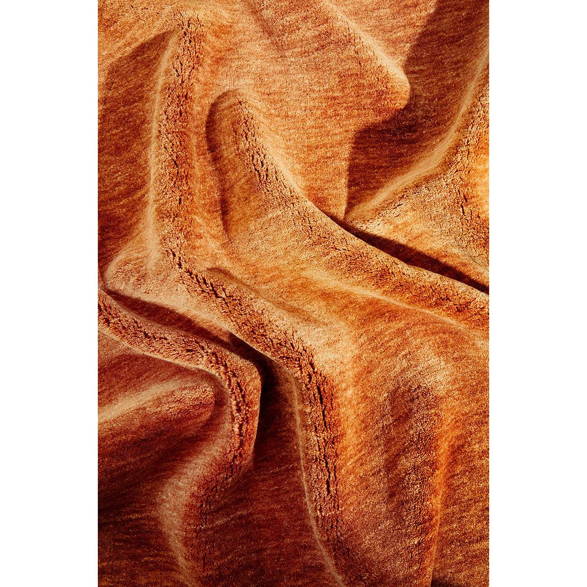 Conscious Loom Kinship Paprika Rug featuring textured paprika orange with copper accents on white background, handwoven wool