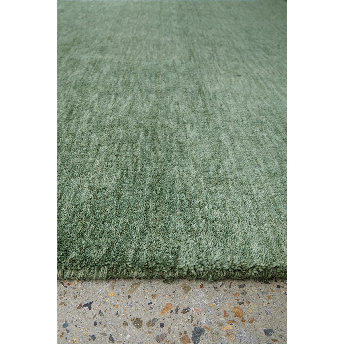 Conscious Loom Kinship Sage Green Runner Rug featuring textured solid in sage green on grey terrazzo, hand-loomed wool