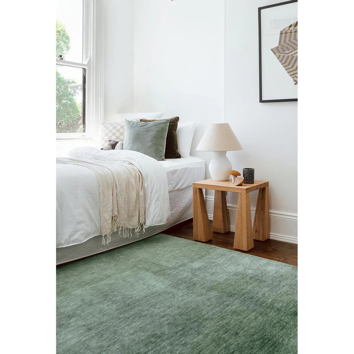 Conscious Loom Kinship Sage Green Rug featuring solid texture in sage green, cream on brown floor, hand-tufted wool
