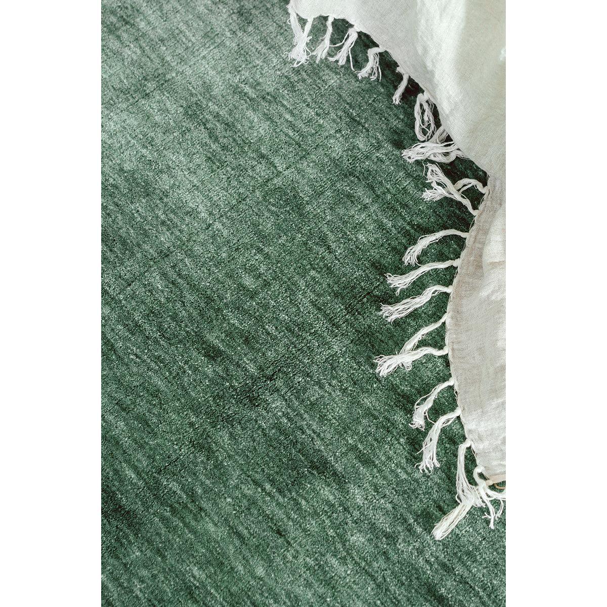 Conscious Loom Kinship Sage Green Rug featuring pattern in sage, emerald and olive on cream backdrop, handwoven wool