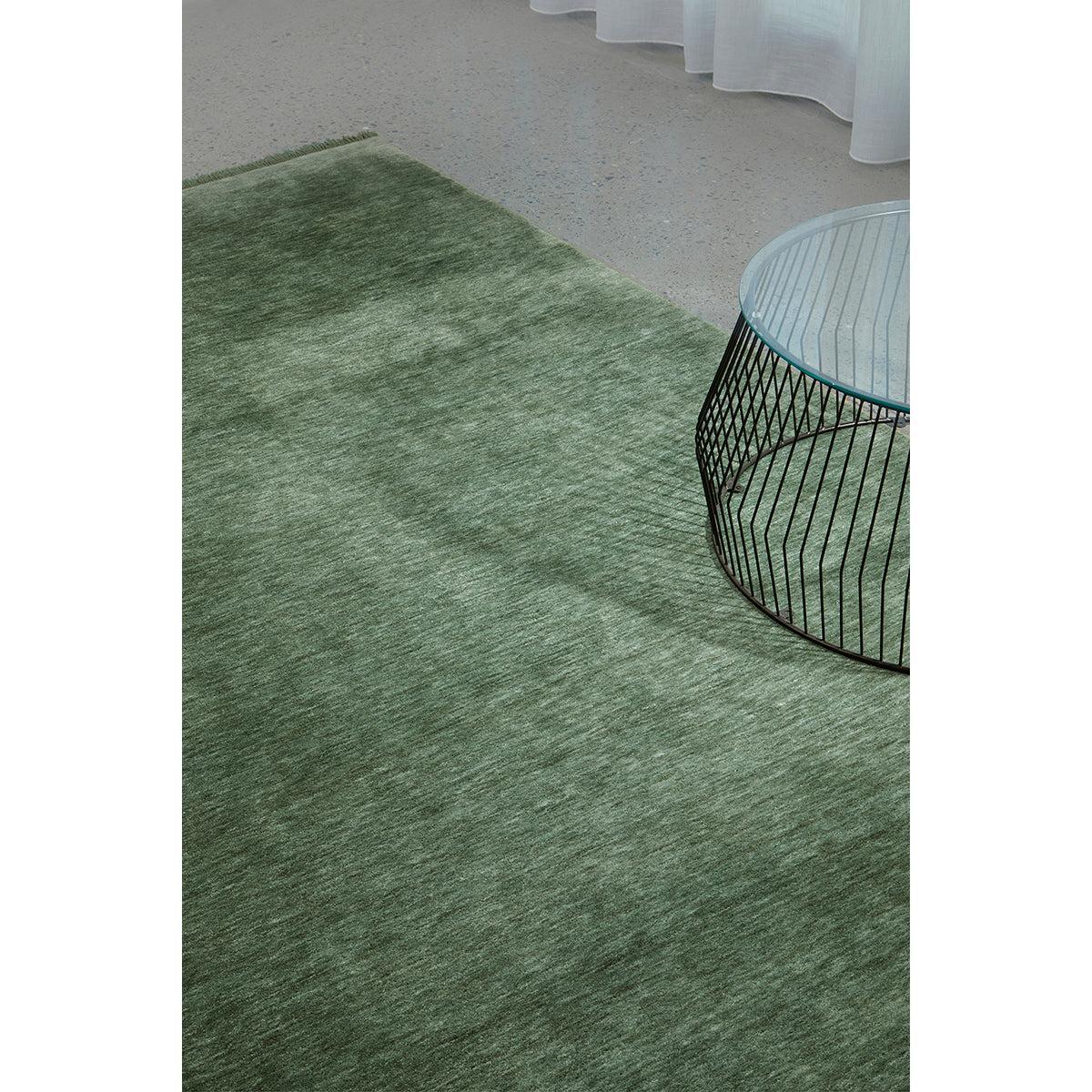 Conscious Loom Kinship Sage Green Rug with textured pile in sage green, moss and olive on light grey floor, unknown