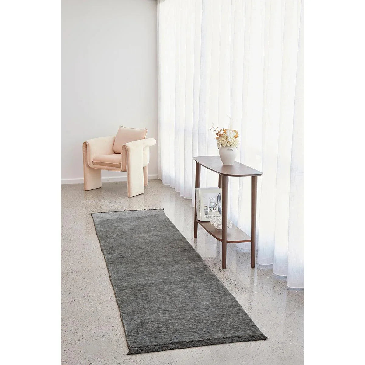 Conscious Loom Kinship Seal Grey Rug featuring slate grey runner on white backdrop, blush pink accents, hand-woven wool