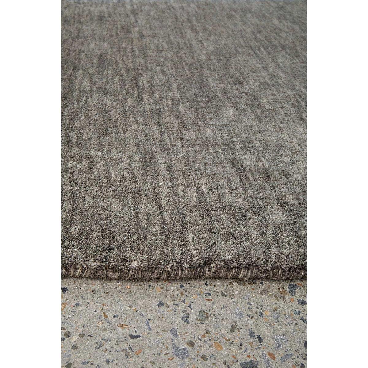 Conscious Loom Kinship Seal Grey Rug textured solid in seal grey, charcoal, taupe on light grey background, tufted wool