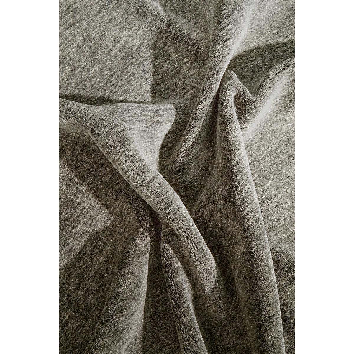 Conscious Loom Kinship Seal Grey Rug featuring textured weave in seal grey, charcoal and taupe on white, woven wool