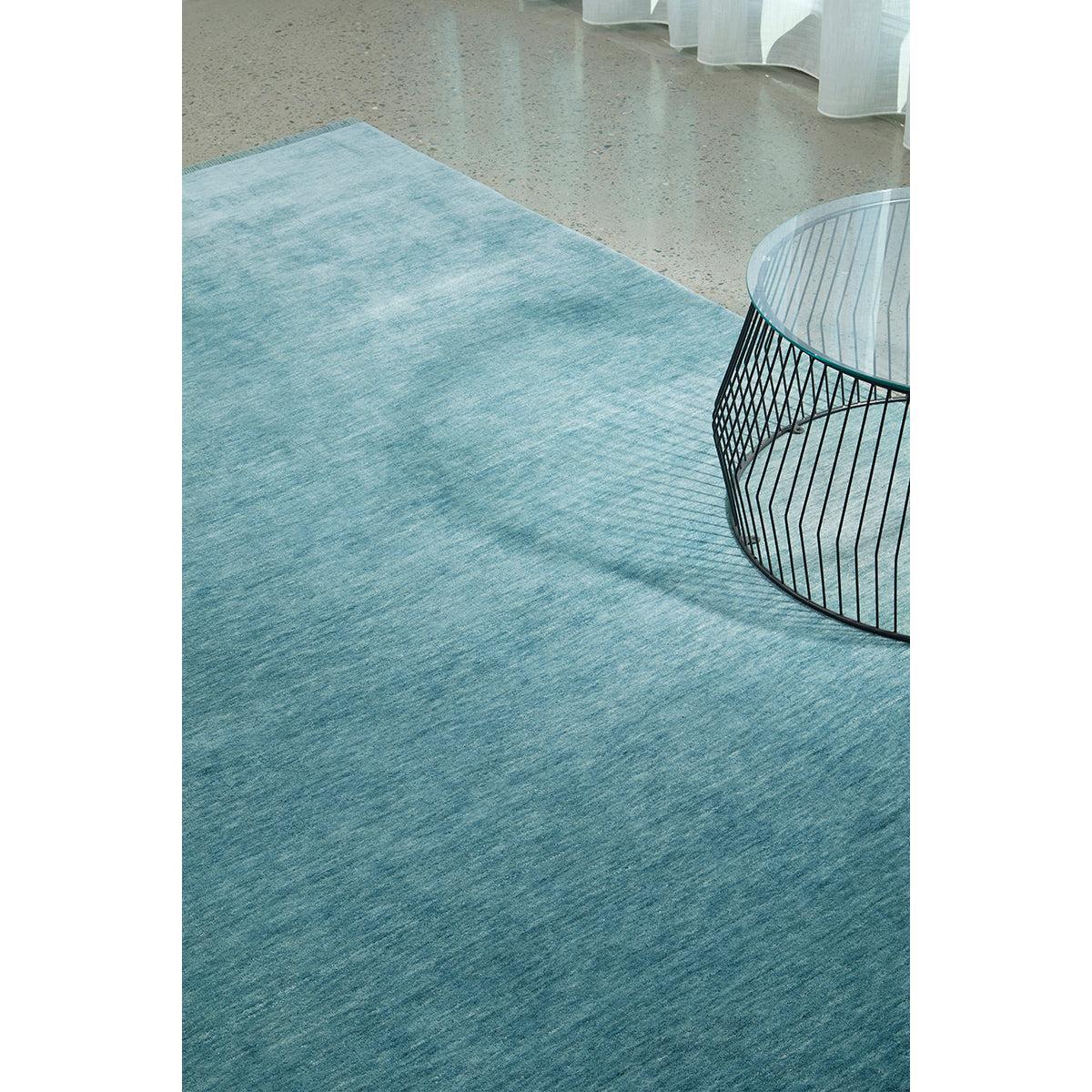 Conscious Loom Kinship Sky Blue Rug featuring gradient in sky blue, turquoise, teal on grey background, handloom wool