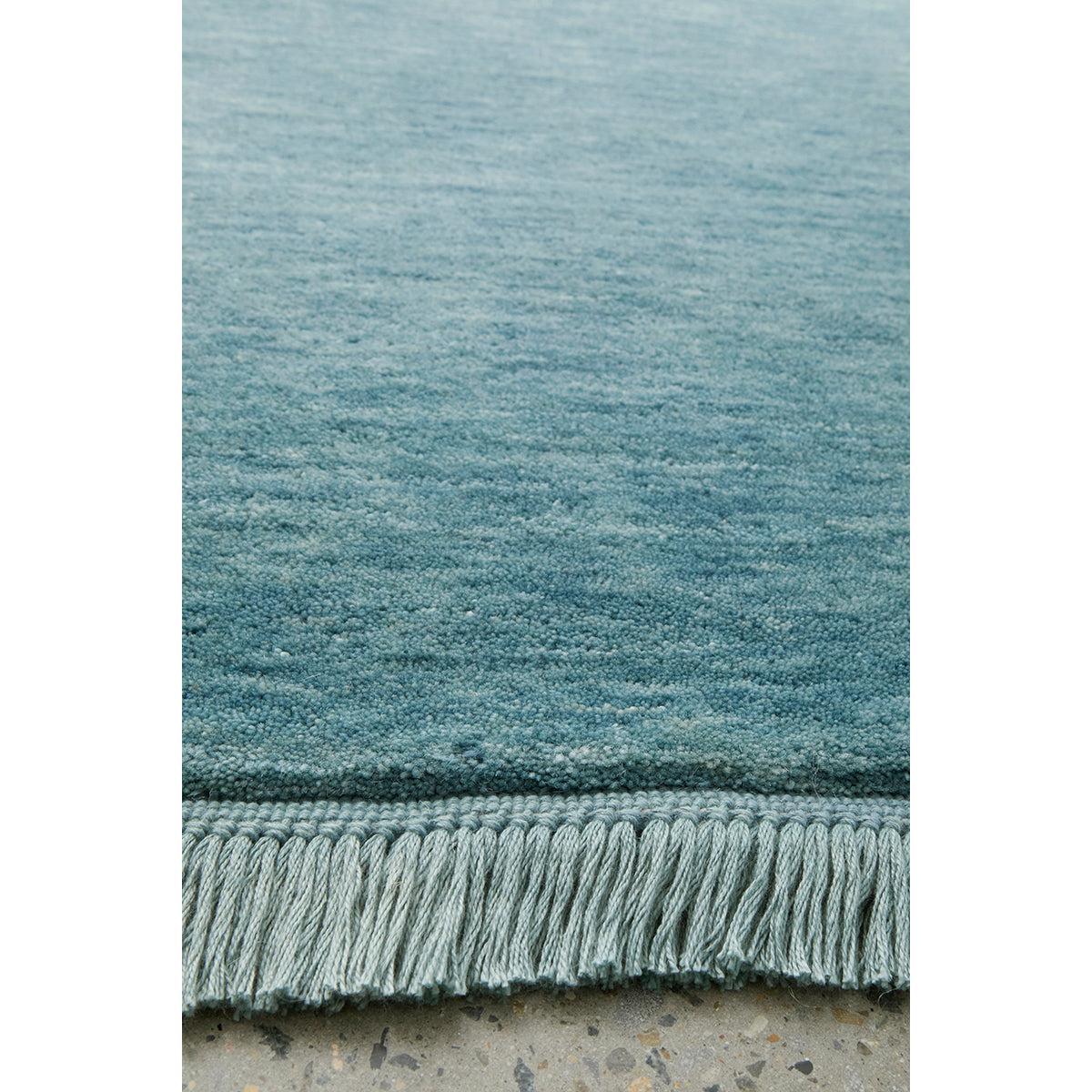 Conscious Loom Kinship Rug featuring tonal gradient in teal and blue-teal on light grey, hand-tufted wool