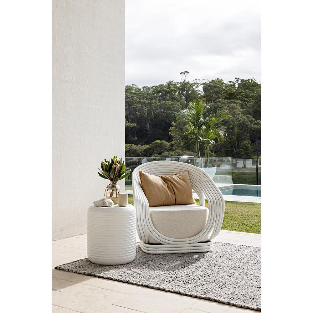 Darren Palmer Bedrock Grey Rug featuring textured weave in grey and charcoal on beige patio, machine-woven polypropylene