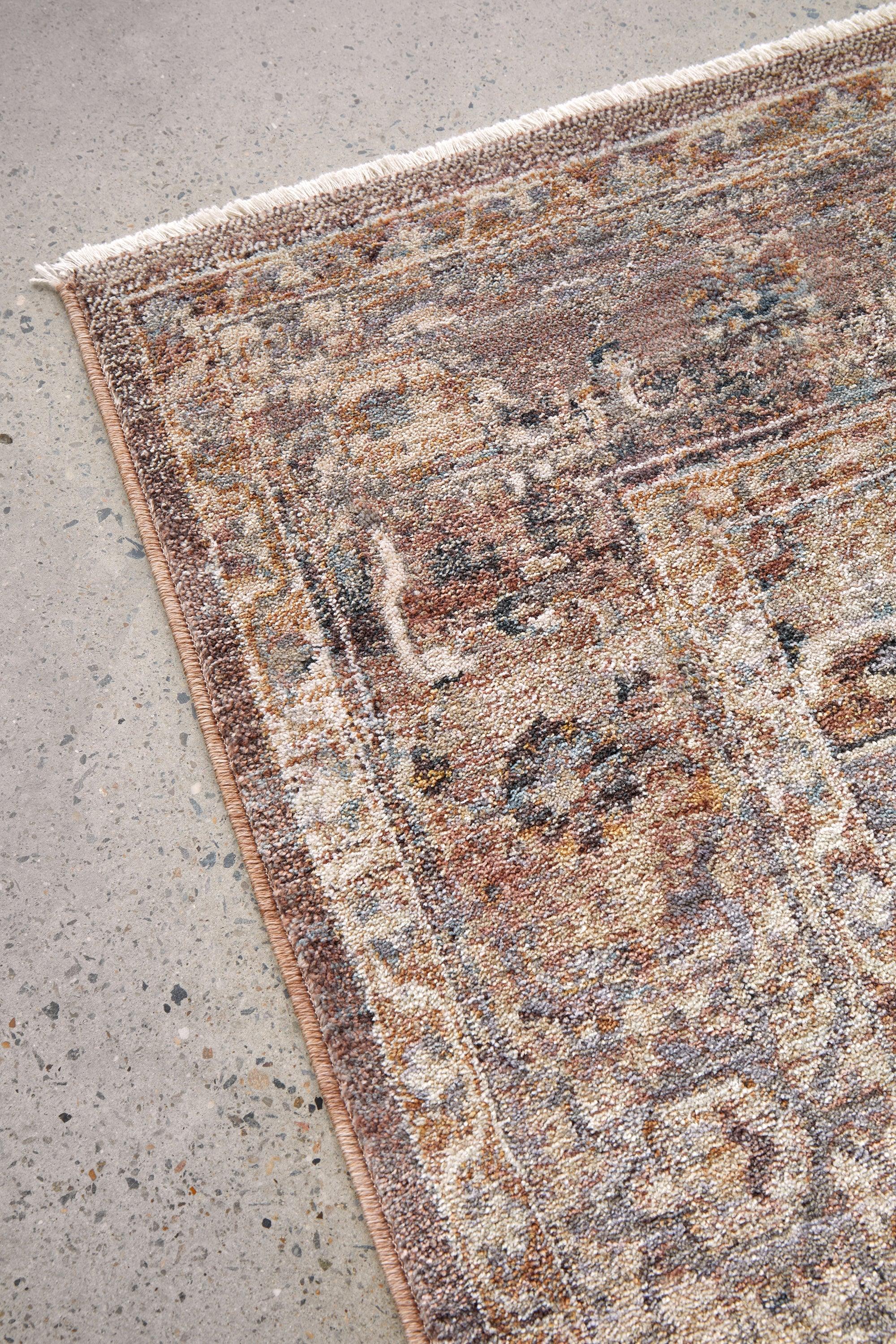 Darren Palmer Heirloom Plum Rug featuring old-world ornate pattern in plum, brown, cream on grey floor, hand-tufted wool