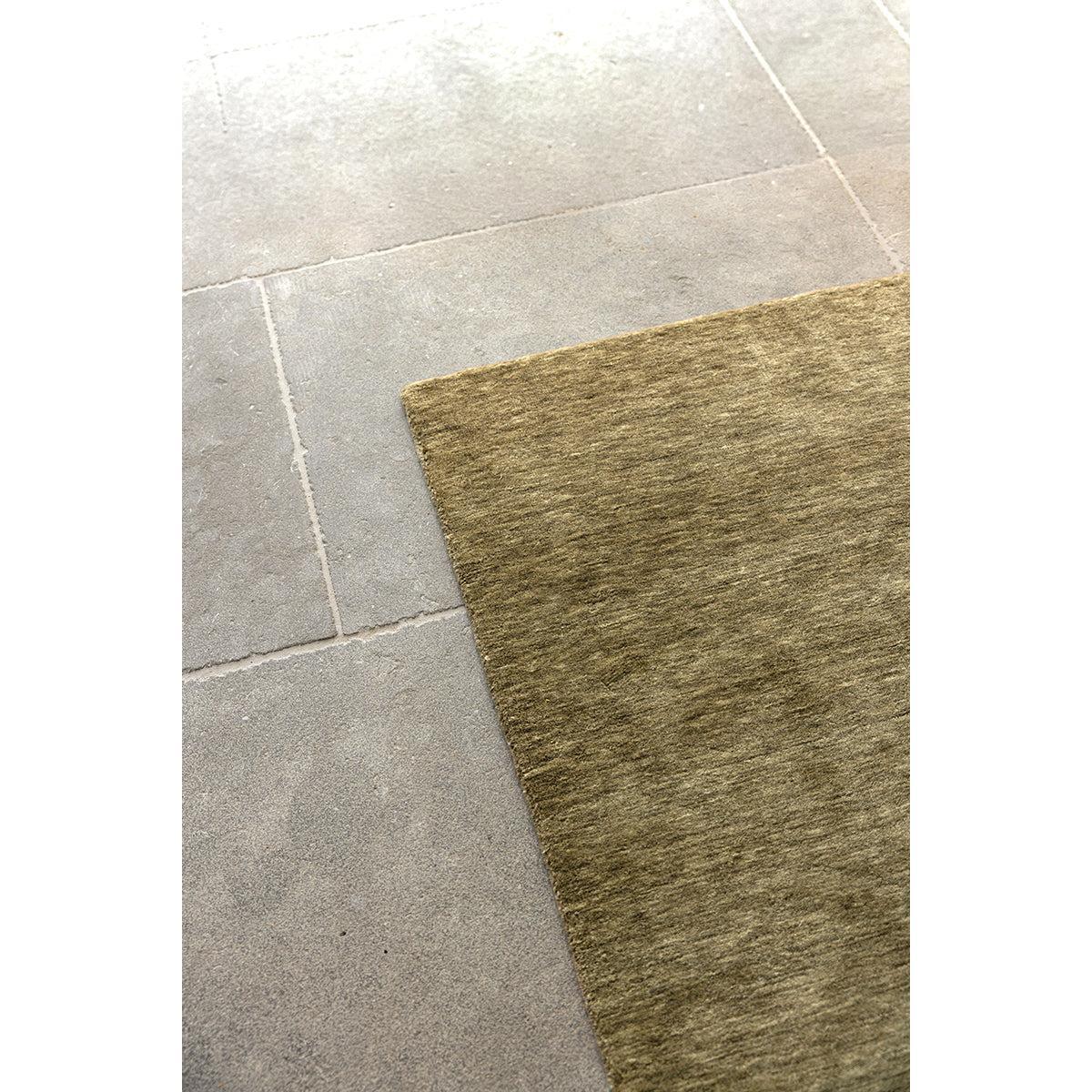 Darren Palmer Olive Runner Rug with textured solid pattern in olive, khaki, taupe on grey floor, machine-woven wool