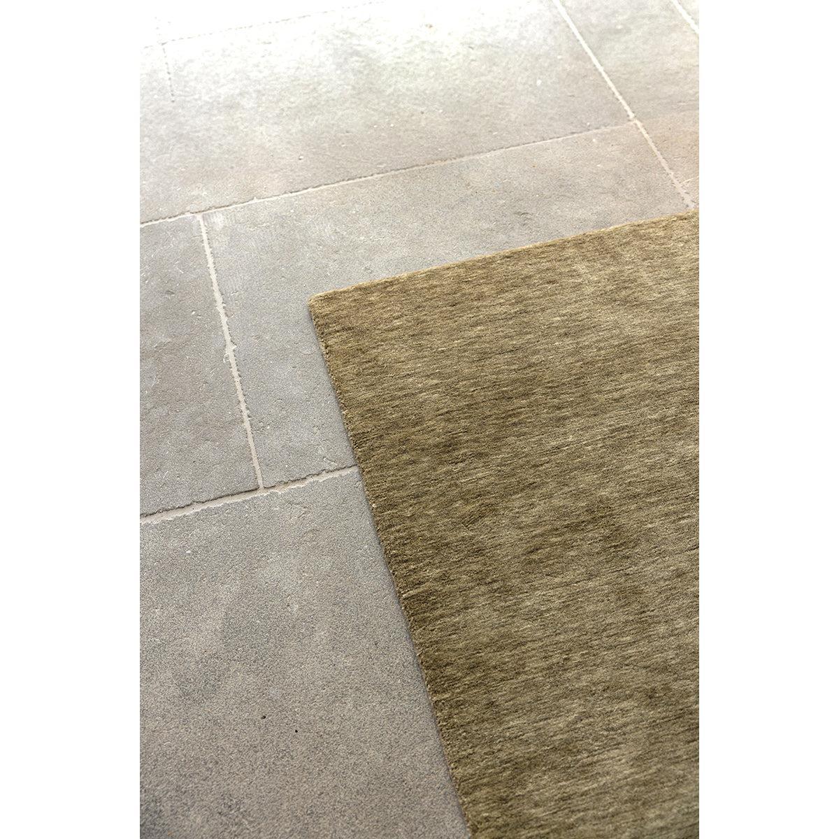 Darren Palmer Legacy Olive Rug featuring textured olive on light grey tile floor, construction unknown, material unknown