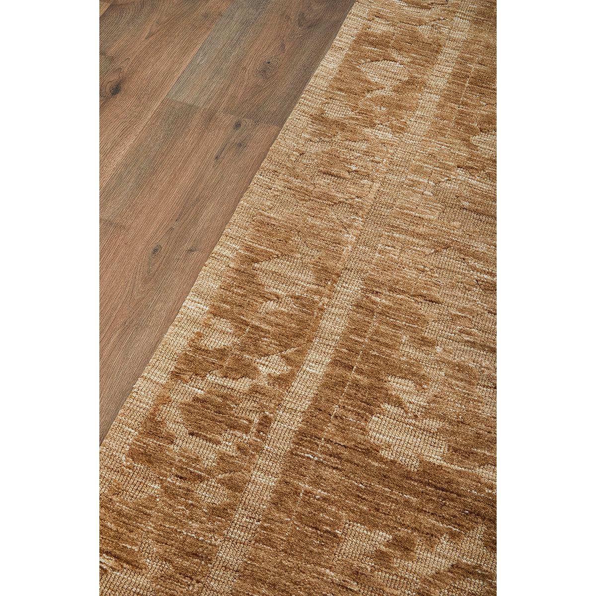 Darren Palmer Malabar Ginger Rug with oriental pattern in ginger caramel and beige on brown wood floor, woven wool