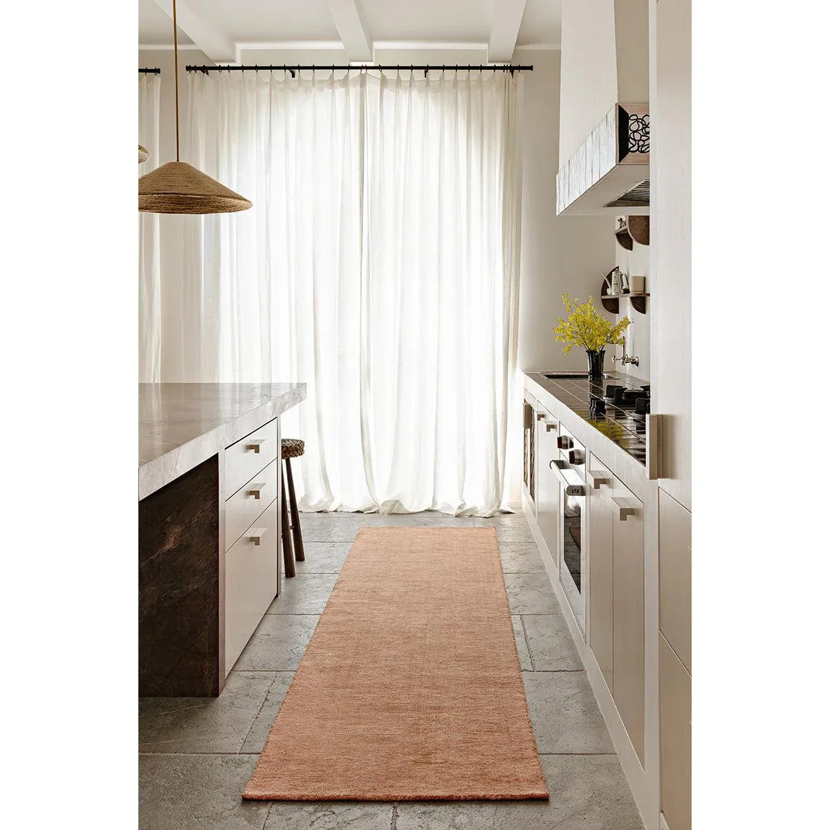 Darren Palmer Origin Clay Runner Rug featuring a solid weave in clay on light grey tiled floor, machine-made wool