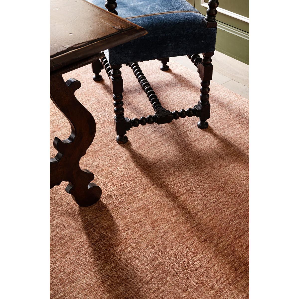 Darren Palmer Origin Clay Rug featuring solid-colour design in clay, camel and taupe on beige floor, machine-woven wool