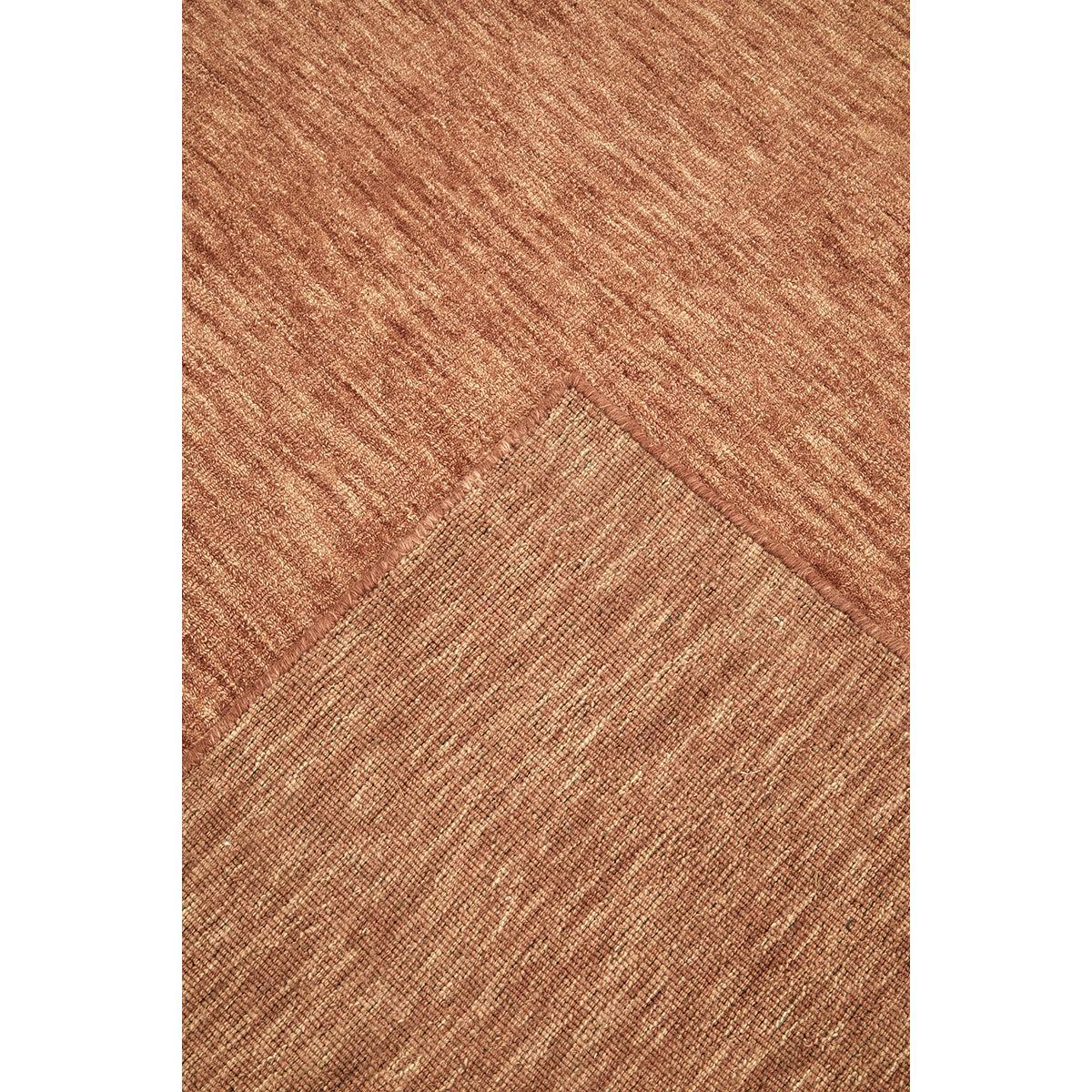 Darren Palmer Origin Clay Rug featuring textured diagonal weave in clay, terracotta and beige on white, tufted wool