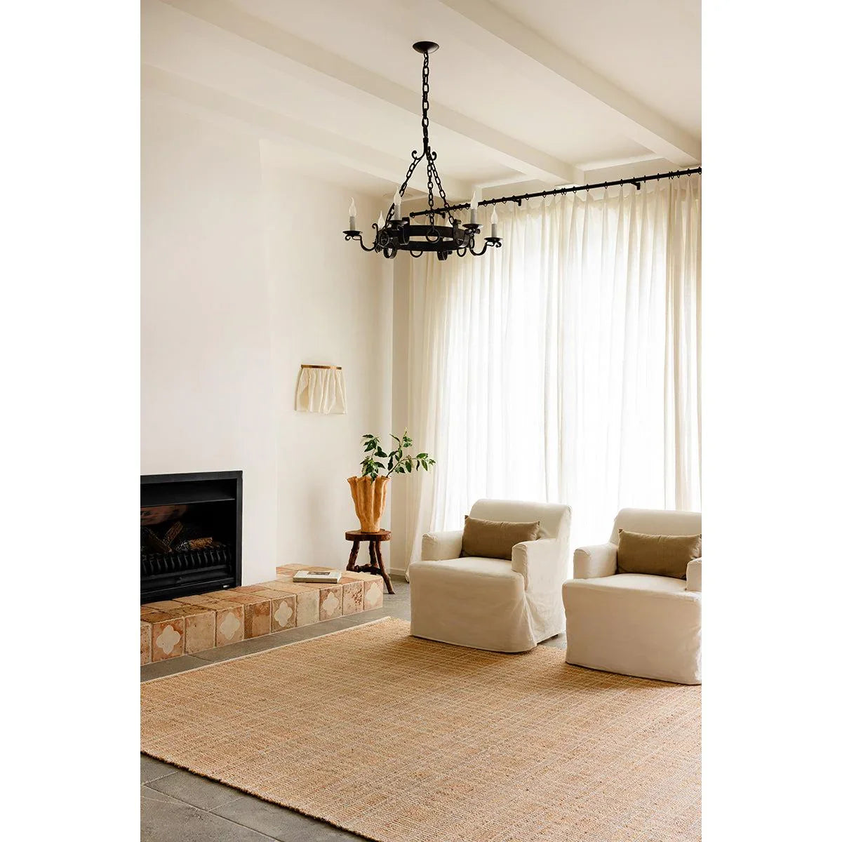 Darren Palmer Plaid Sandstone Rug featuring plaid pattern in sandstone beige, cream and ivory on grey floor, woven jute