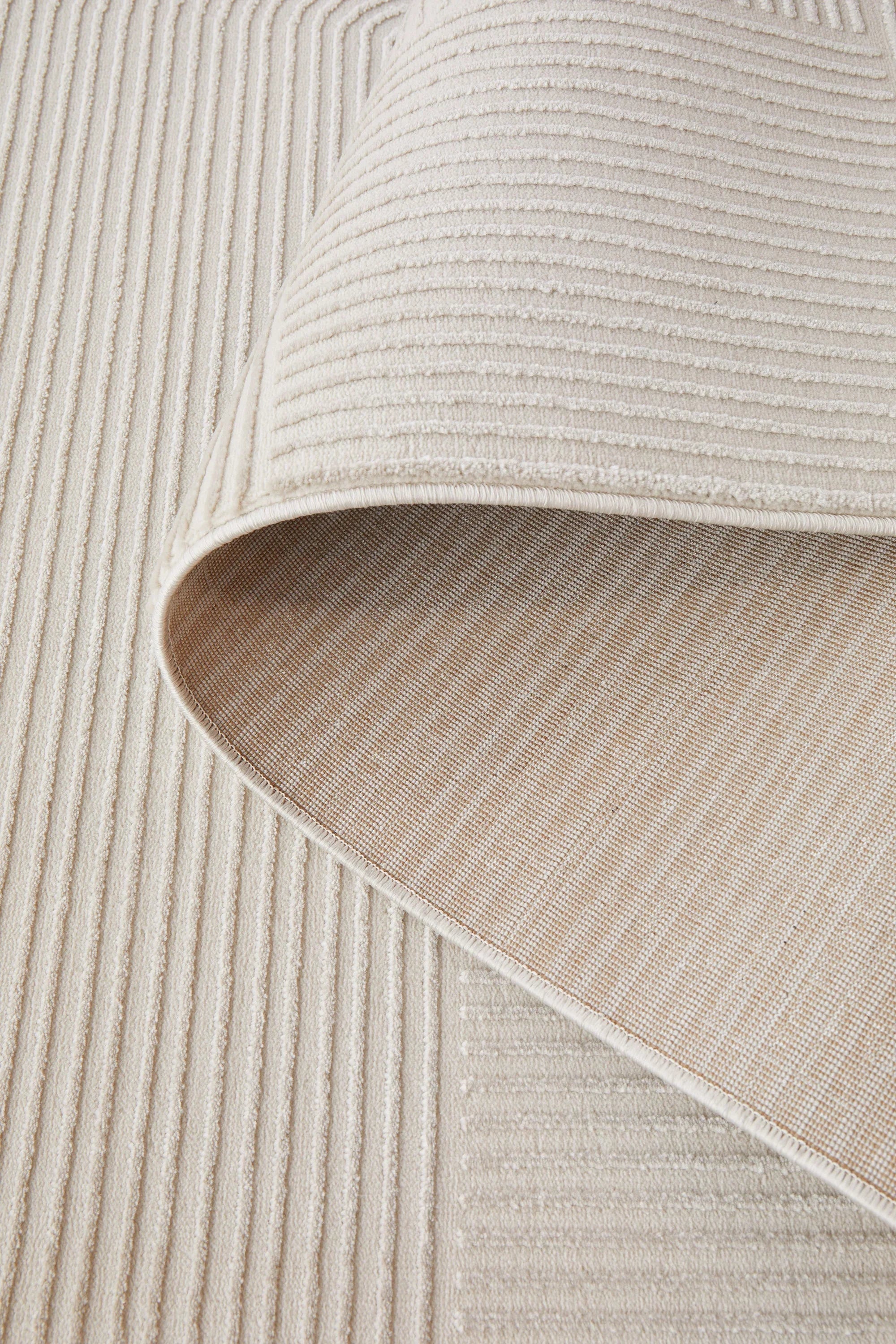 Darren Palmer Raking Linen Rug featuring vertical ribbing in cream, ivory and taupe on ivory base, machine-made linen