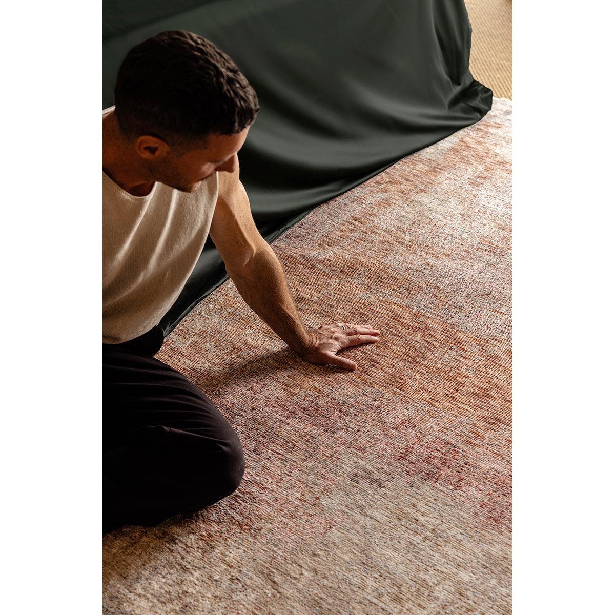Darren Palmer Sierra Dusk Rug featuring distressed pattern in terracotta, peach and cream on warm beige background, hand-tufted wool