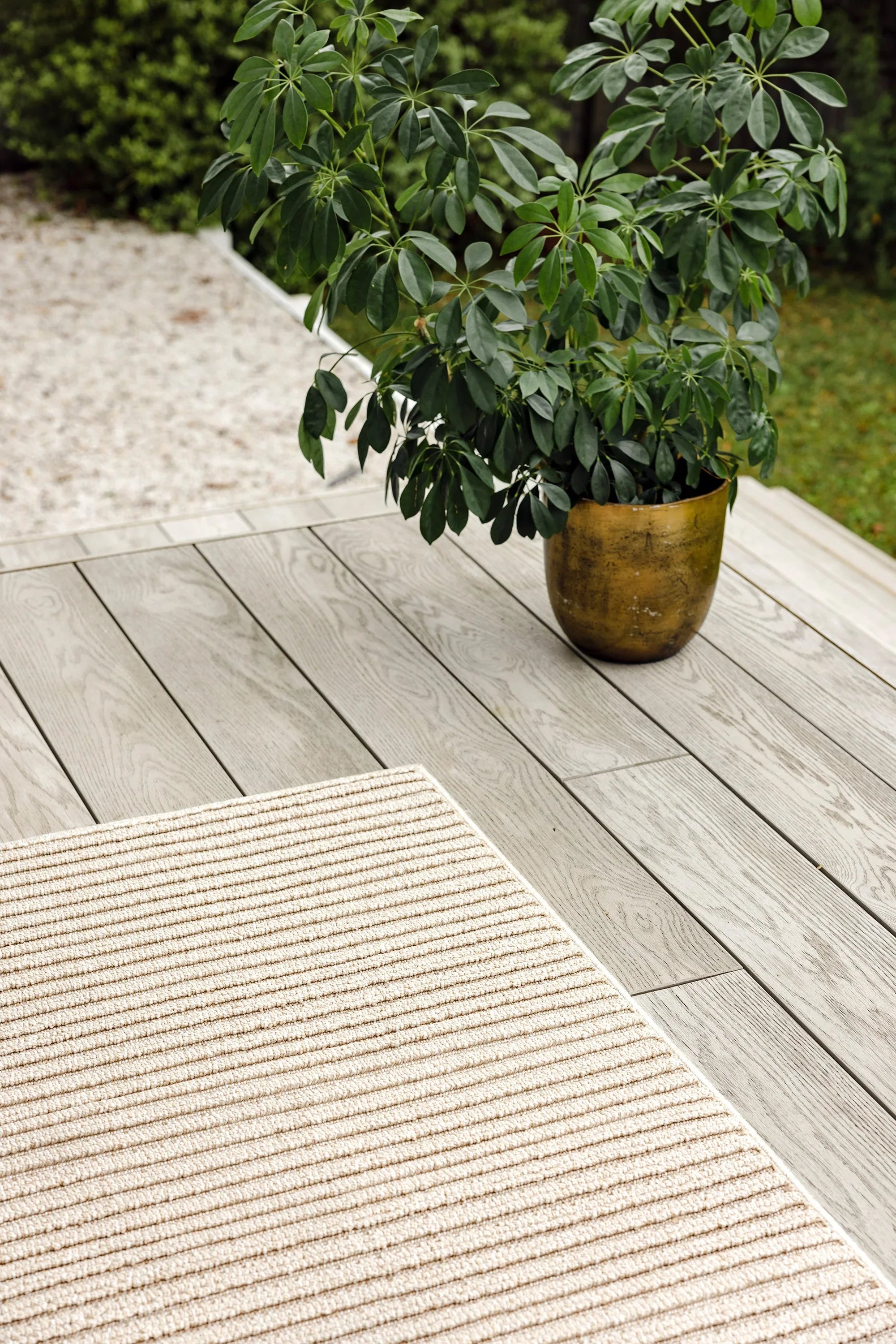 Darren Palmer Sandridge Taupe Indoor/Outdoor Rug with ribbed stripe in taupe/cream on grey deck, woven polypropylene