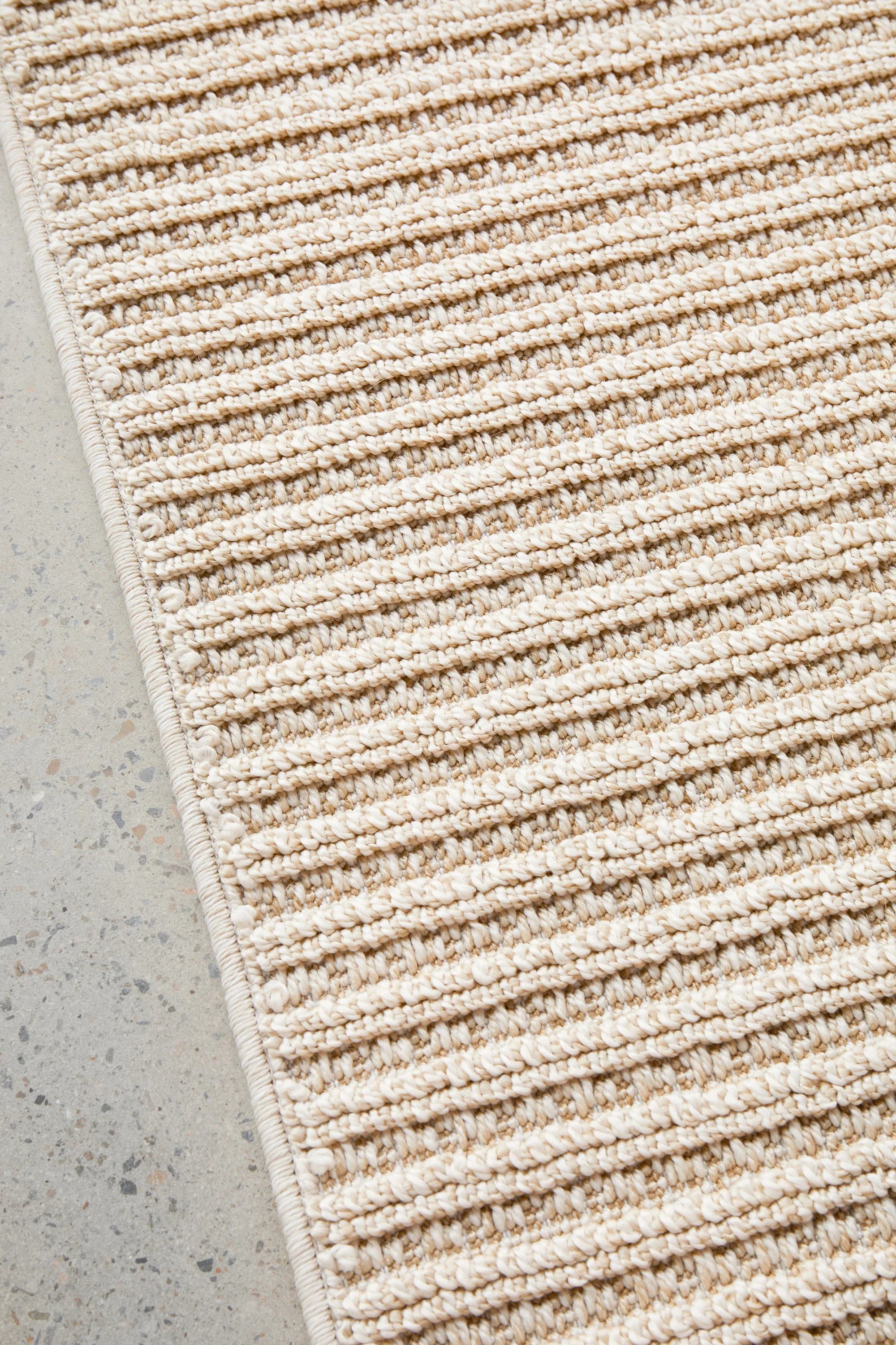 Sandridge Taupe Indoor/Outdoor Rug featuring textured ribbed stripes in taupe and cream on beige
