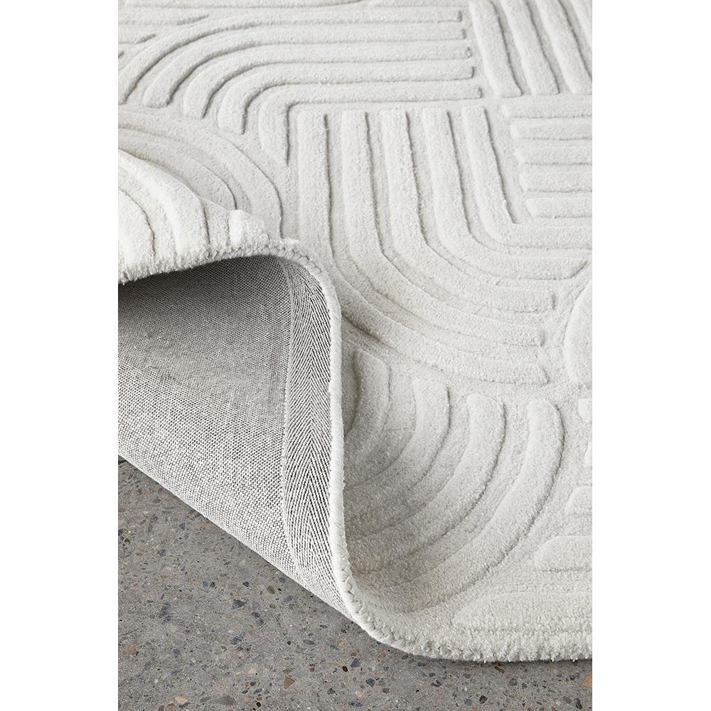 Darren Palmer Zen White Rug featuring curved geometric pattern in ivory, cream and white on white background, hand-tufted wool